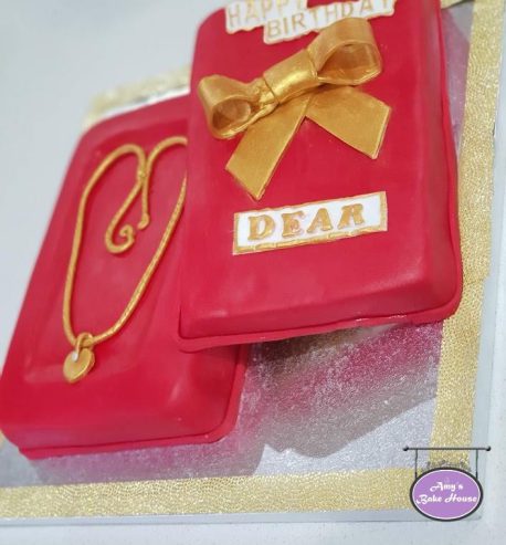 attachment-https://www.amysbakehouse.com.au/wp-content/uploads/2021/11/edible-gold-necklace-gift-box-cake-1-458x493.jpg