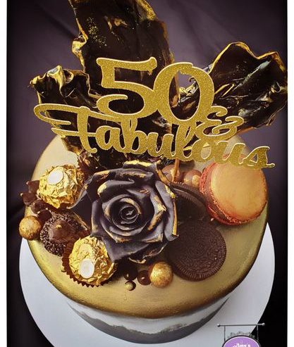 attachment-https://www.amysbakehouse.com.au/wp-content/uploads/2022/02/Black-Gold-Chocolate-Themed-Cake1-417x493.jpg